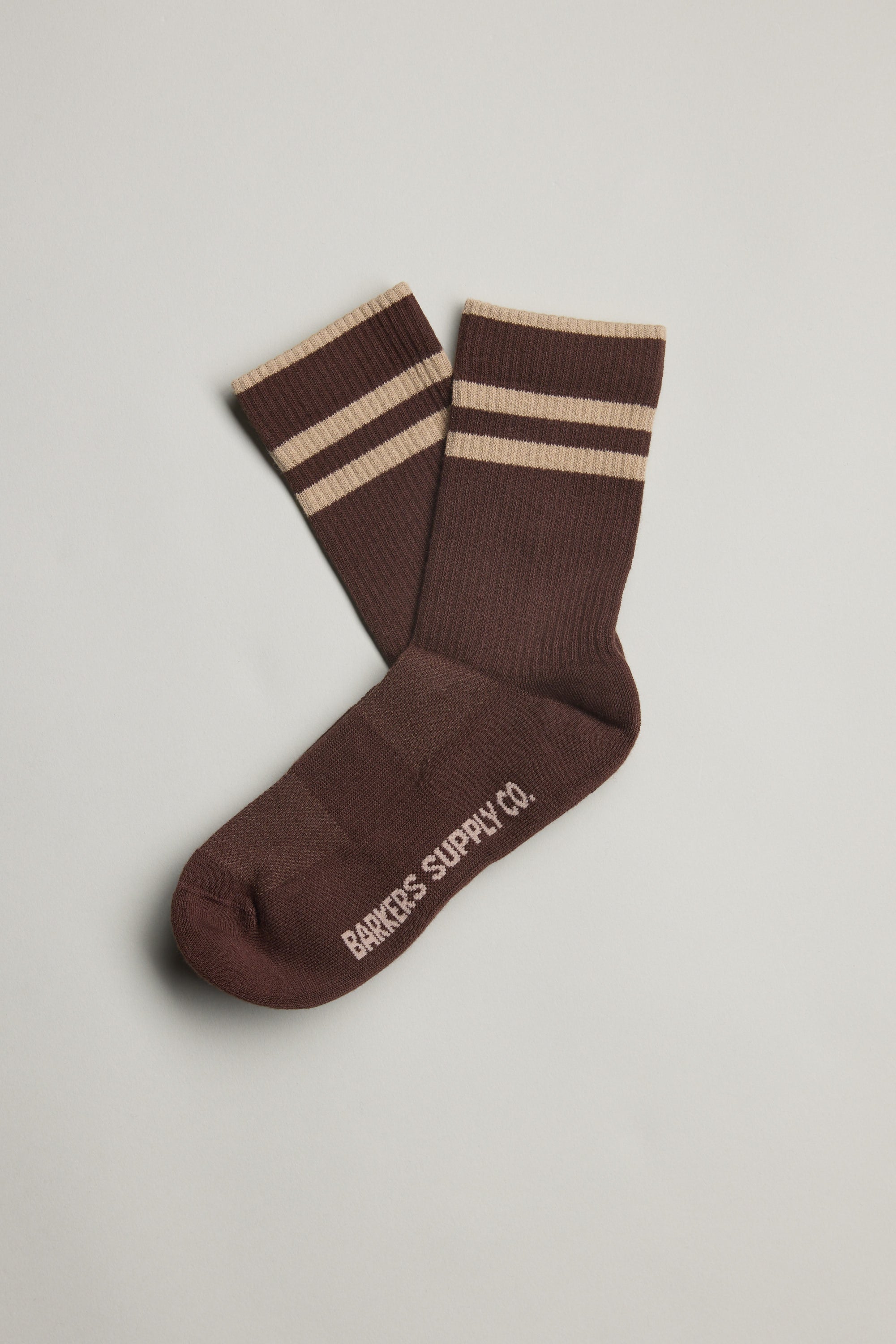 Emerson Sport Sock by Barkers in brown with beige stripes and brand text on the sole, laid flat.