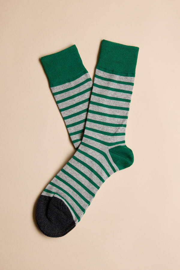 The Mojave Stripe Sock by Barkers is a gray cotton sock with green stripes, heels, toes, and cuffs—ideal for those seeking comfort and style.