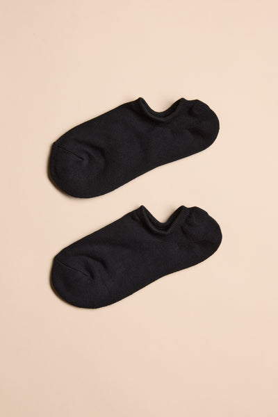 A Barkers Ankle Sock in black, made from responsibly sourced cotton by Barkers, laid flat on a beige background and designed for all-day comfort.