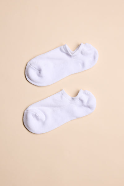 A pair of Barkers Ankle Socks in plain white, crafted from responsibly sourced cotton, laid flat and parallel on a light beige background for all-day comfort. Brand: Barkers.