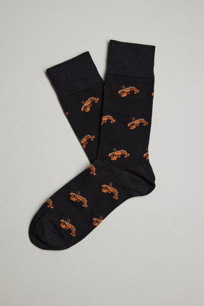 A pair of Barkers Ray Crayfish Socks, featuring an all-over print of small orange lobsters, are laid flat on a light gray background with one comfy sock slightly overlapping the other.
