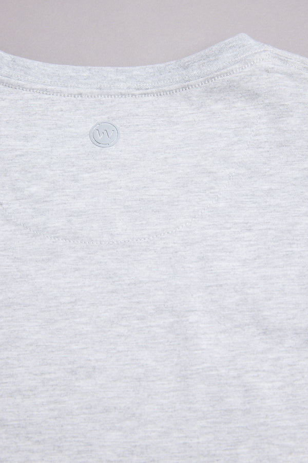 Close-up of the WearEver Outbound T-Shirt's upper back in light grey, featuring a subtle stitched WearEver logo near the neckline against a plain background.