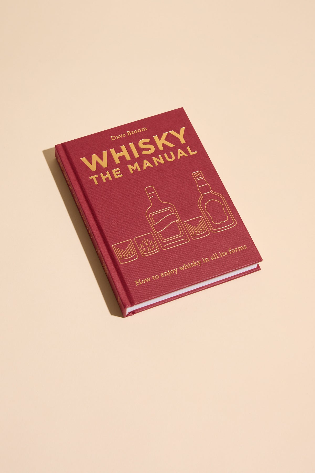 Whisky The Manual by Other—a whisky guide with tasting notes on bottles and glasses.