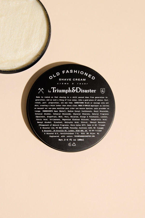 Triumph & Disaster Old Fashioned Shave Cream Jar in black tin, lid off, for men’s grooming.