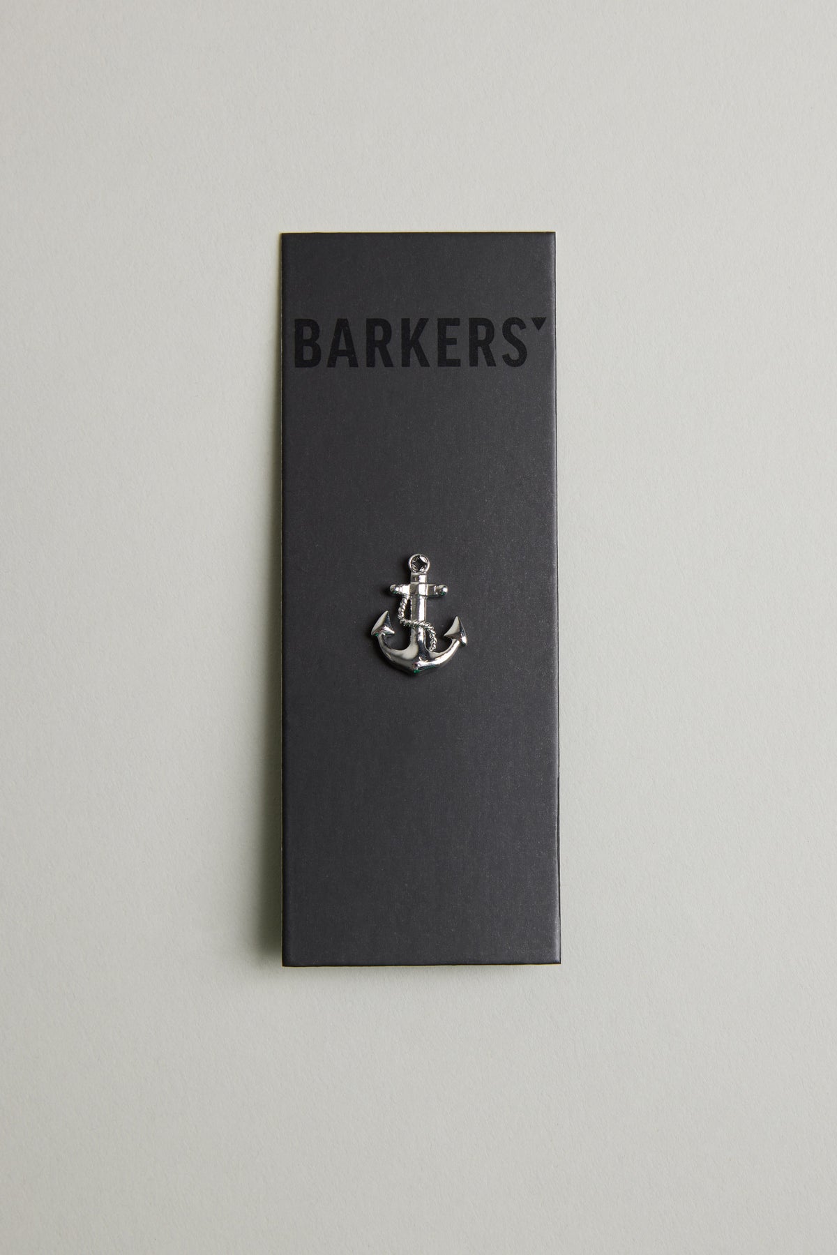 The Barkers Anchor Lapel Pin, displayed on a black card with the brand name at the top and a light grey background, makes an ideal nautical accessory or gift for ocean lovers.