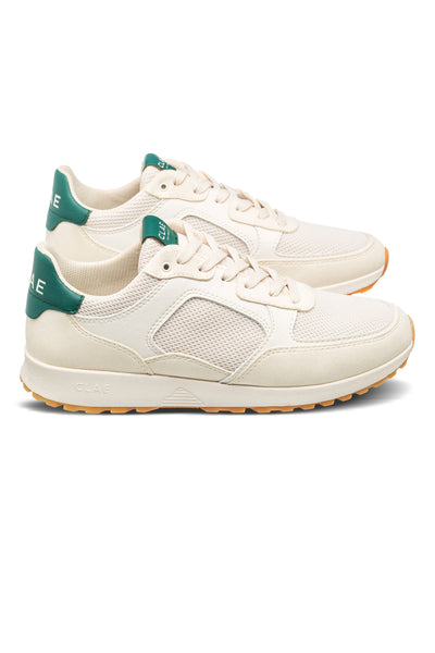 The CLAE Joshua by Clae: off-white sustainable sneakers with green heel accents, mesh panels, and light brown rubber soles, shown side by side facing right.
