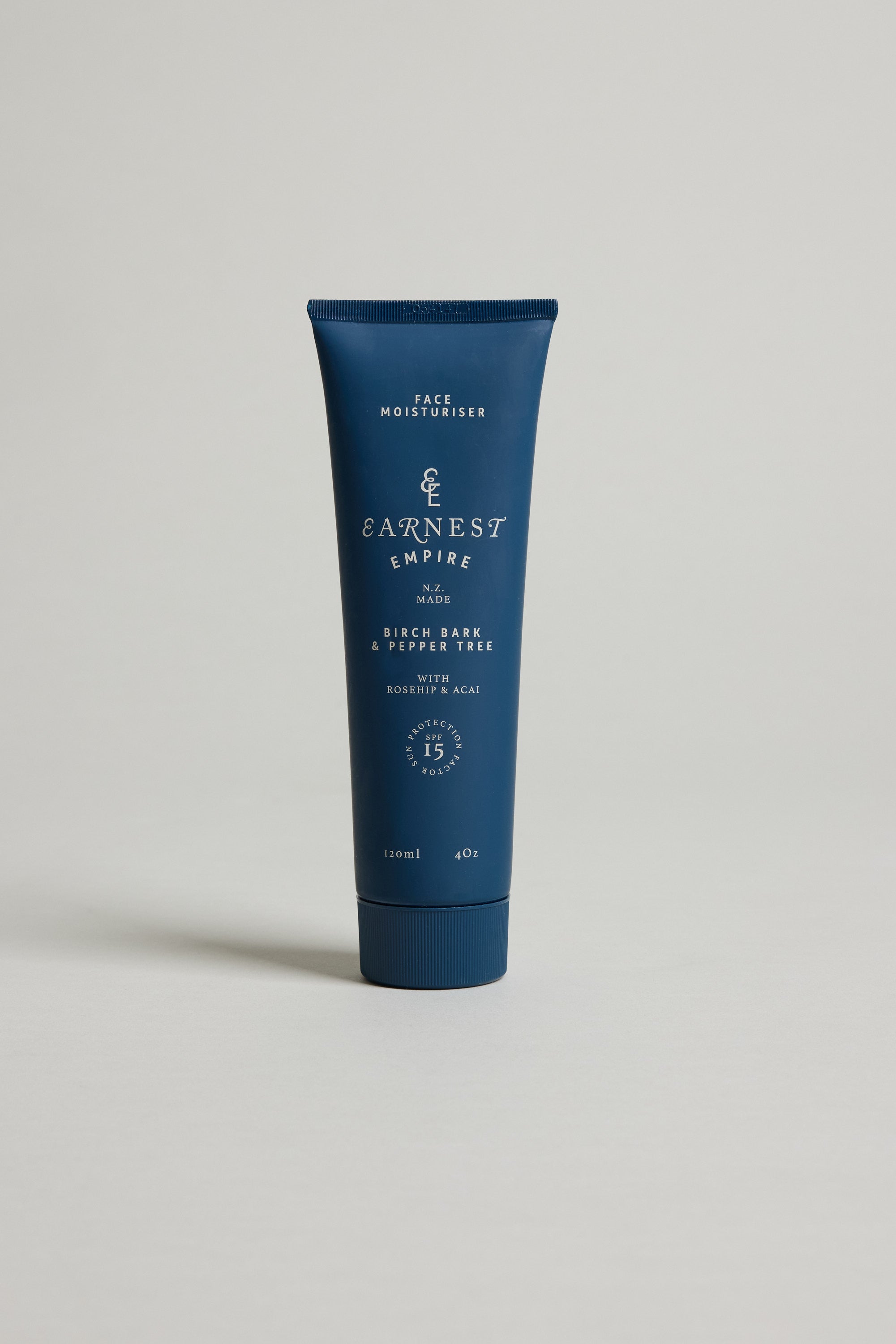 A blue tube of Other Earnest Empire SPF Moisturiser (120ml/4oz) stands upright on a light background. The label highlights birch bark and acai, ideal for sensitive skin, with SPF15 protection.
