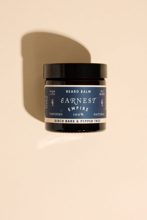 Earnest Empire Beard Balm, birch bark scent, on beige background with shadow.