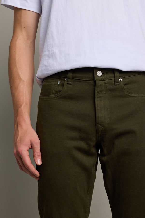 Person wears a white t-shirt and Barkers Wanderer Straight Coloured Jean, regenerative cotton.