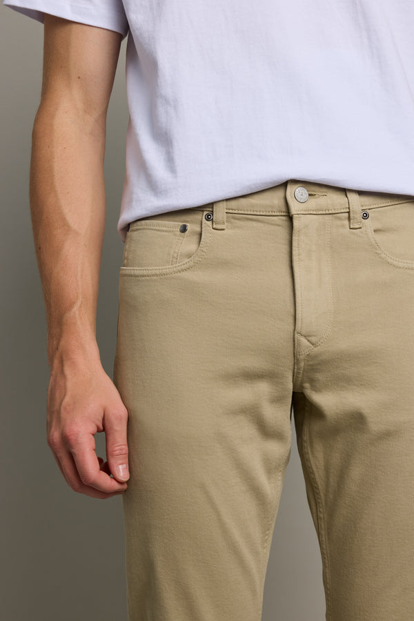 Person wearing a white t-shirt and Barkers Wanderer Straight Coloured Jeans, shoulders to mid-thigh.
