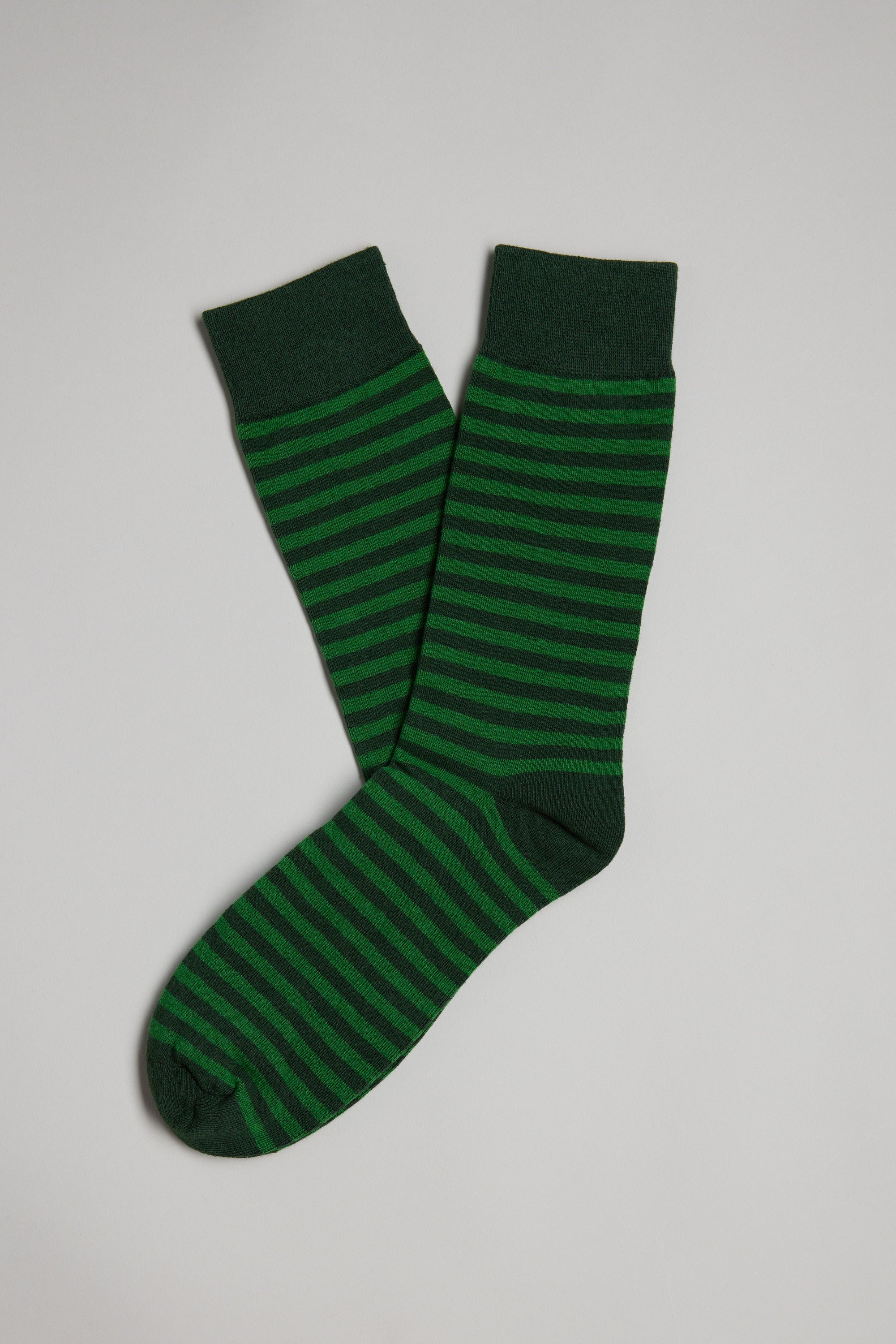 The Evans Stripe Sock by Barkers is a pair of green socks with dark green horizontal stripes, shown laid flat on a light gray background.