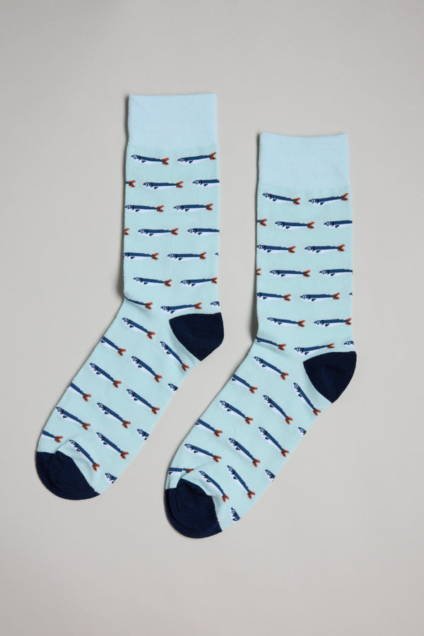 The Barkers Sardine Sock features a light blue cotton design with a fish pattern and dark blue heels and toes—perfect as a stylish gift for men.
