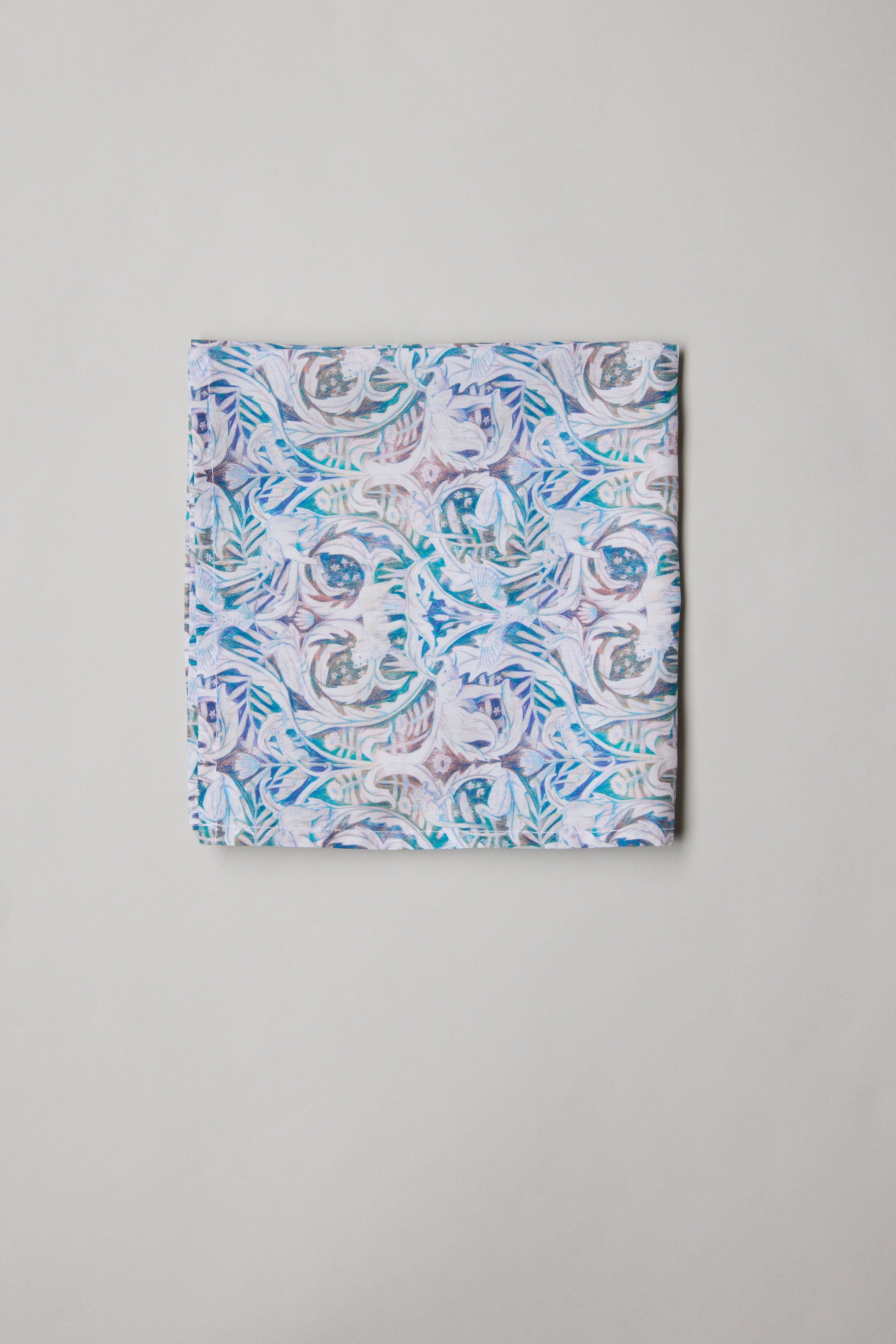 The Liberty Valerie PS by Liberty is a Tana Lawn cotton pocket square featuring an abstract floral pattern in pastel blue, purple, and pink on a light background.