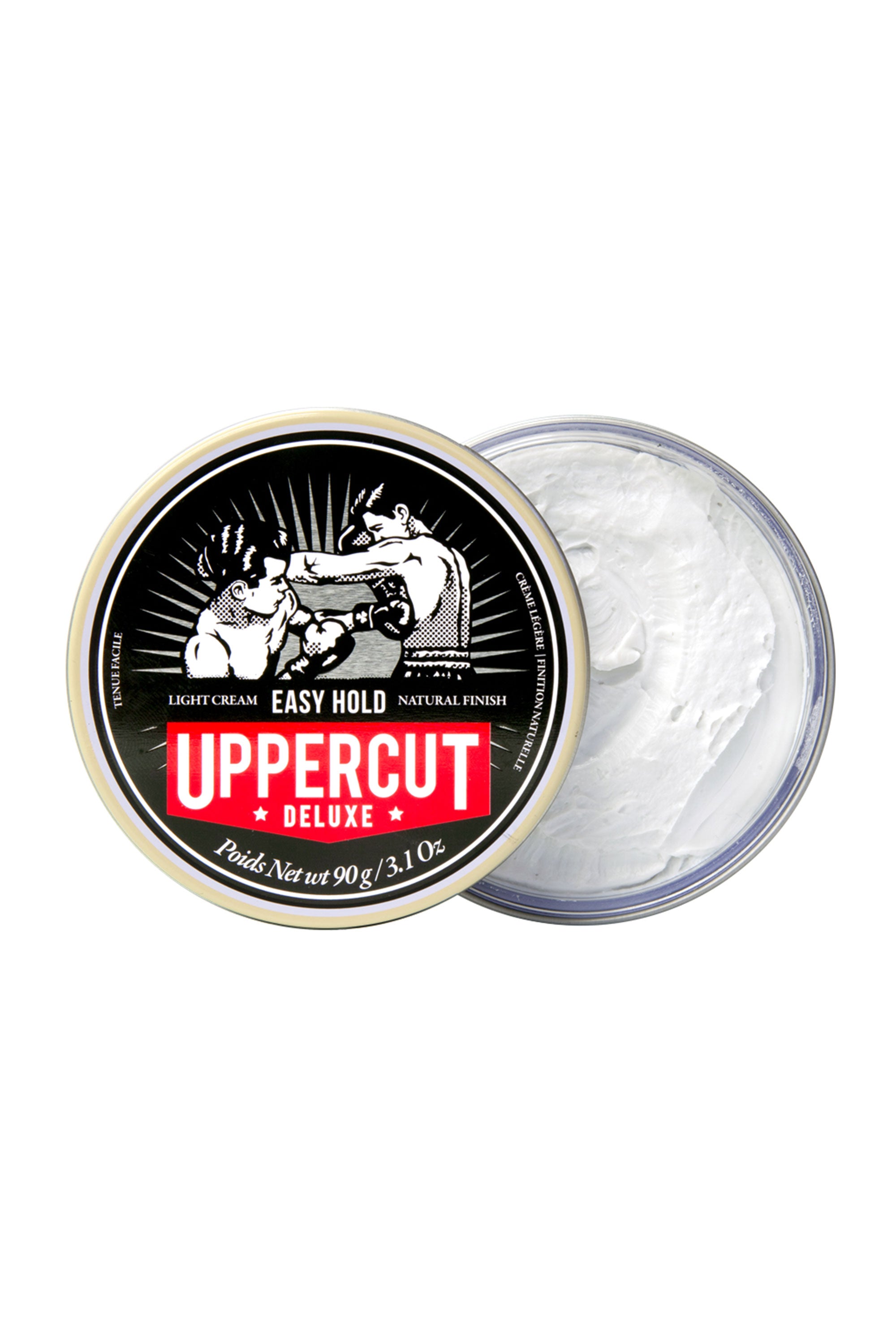 A round container of Uppercut Easy Hold by Other sits with its lid off, showing the light cream inside. The lid displays a vintage boxing illustration with bold red and white branding.