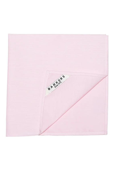 The Tribeca Pocket Square by Barkers is a light pink cotton accessory, neatly folded with a visible white "Barkers Estd. 1972" label—perfect for adding refined style to any formal outfit.
