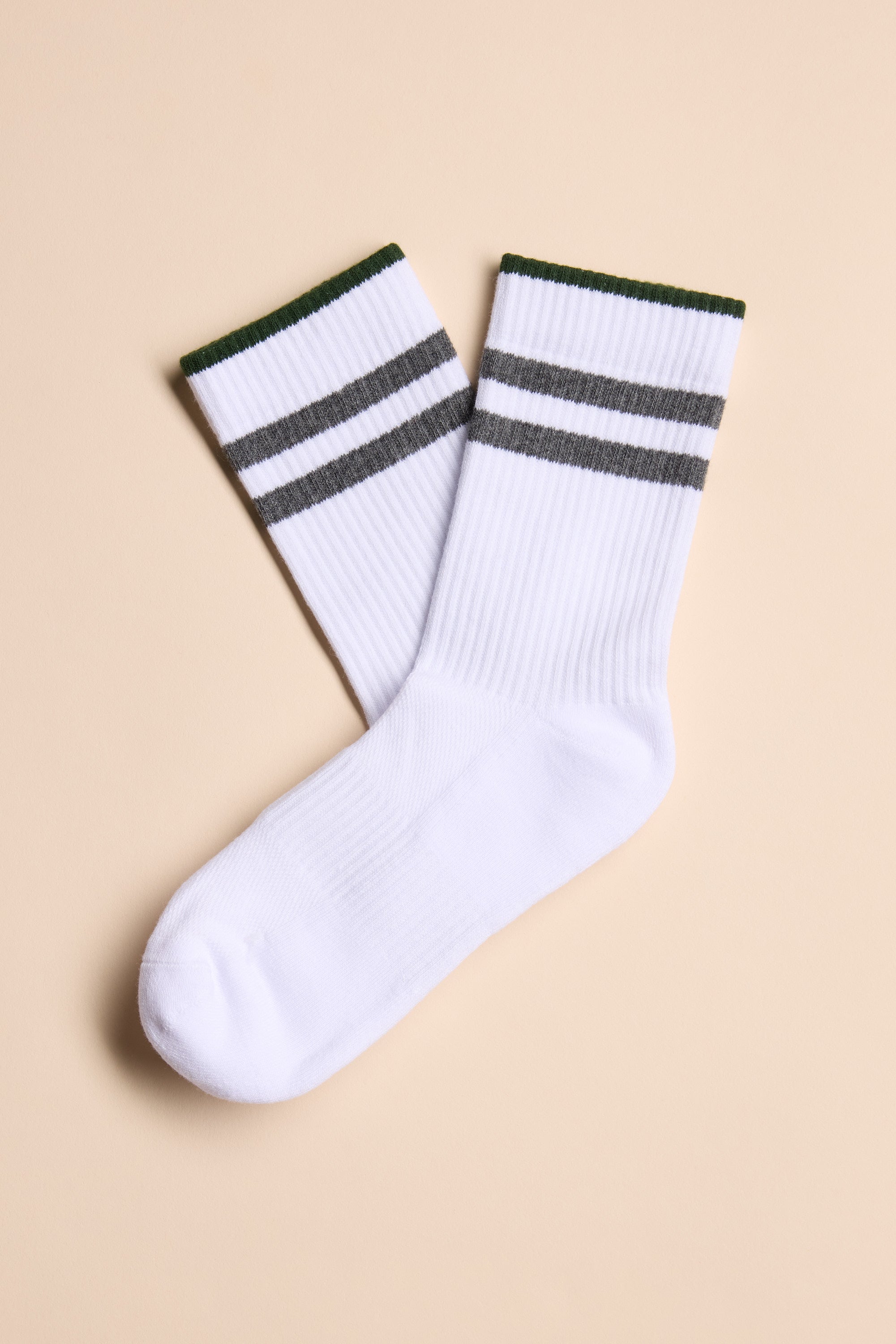 The Barkers Emerson Sport Sock is a pair of white cotton crew socks featuring two dark gray stripes near the top, shown laid flat on a beige background.