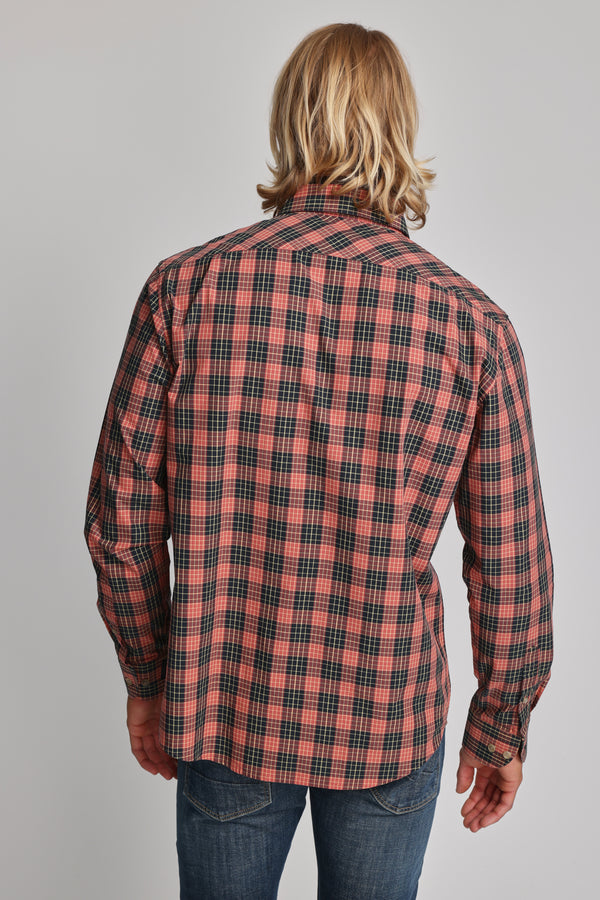 A person with shoulder-length blonde hair is shown from the back, wearing the Barkers Formby Long Sleeve Shirt in red and black plaid with blue jeans, against a plain light gray background.