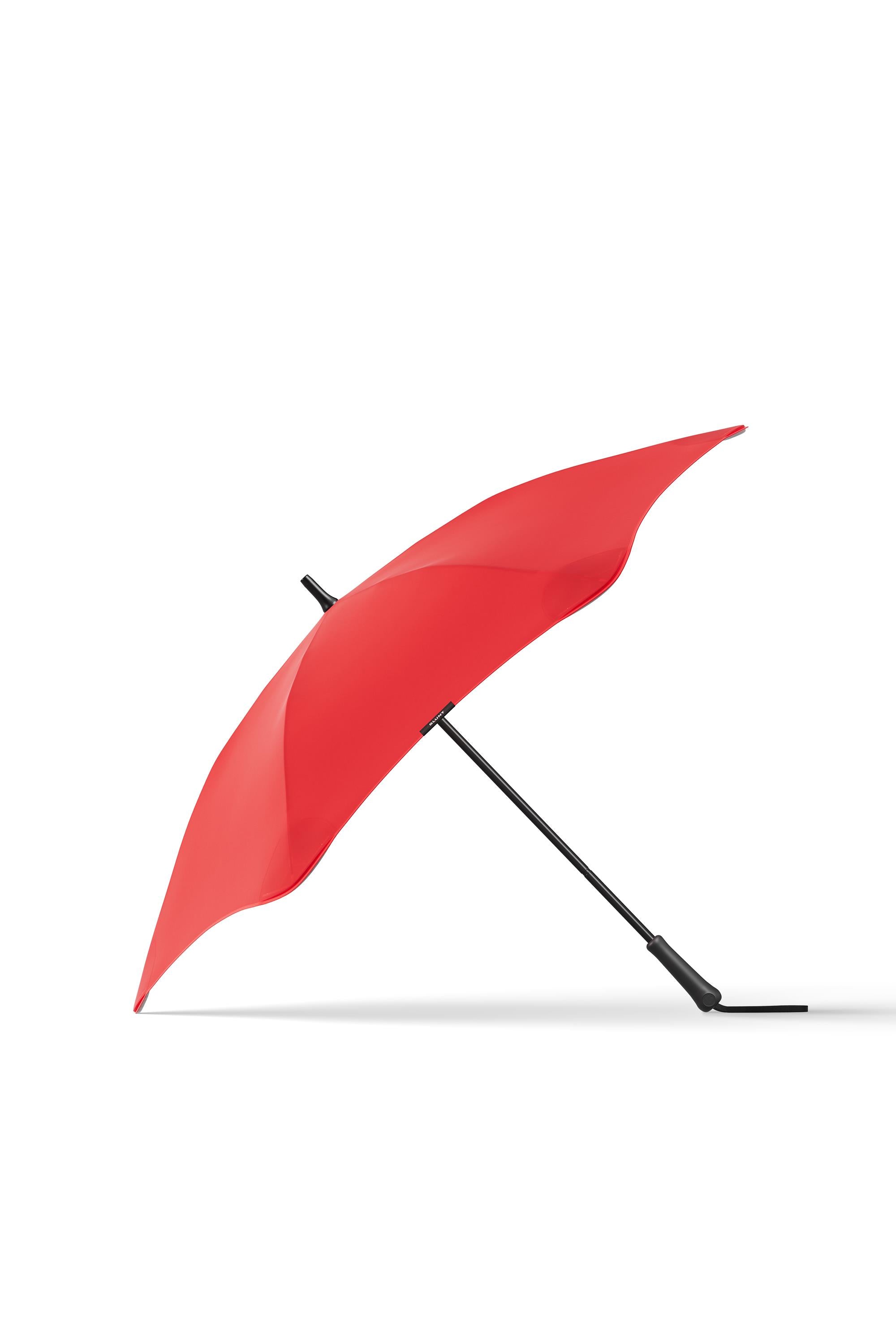 The Blunt Classic 2.0 by Blunt is a red, full-length umbrella featuring a uniquely curved, aerodynamic canopy and black handle, displayed open against a plain white background for optimal rain protection.