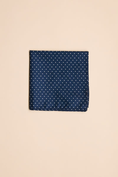 The Barkers Polka Dot Pocket Square is a finely crafted navy cotton accessory with small white polka dots, shown here neatly folded against a plain beige background.