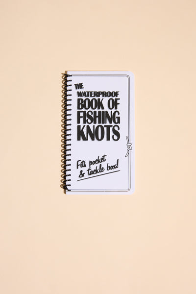 The spiral-bound "Fishing Knots" book by Other is shown on a beige background, with the cover stating "Fits pocket & tackle box!" and featuring a small knot illustration.