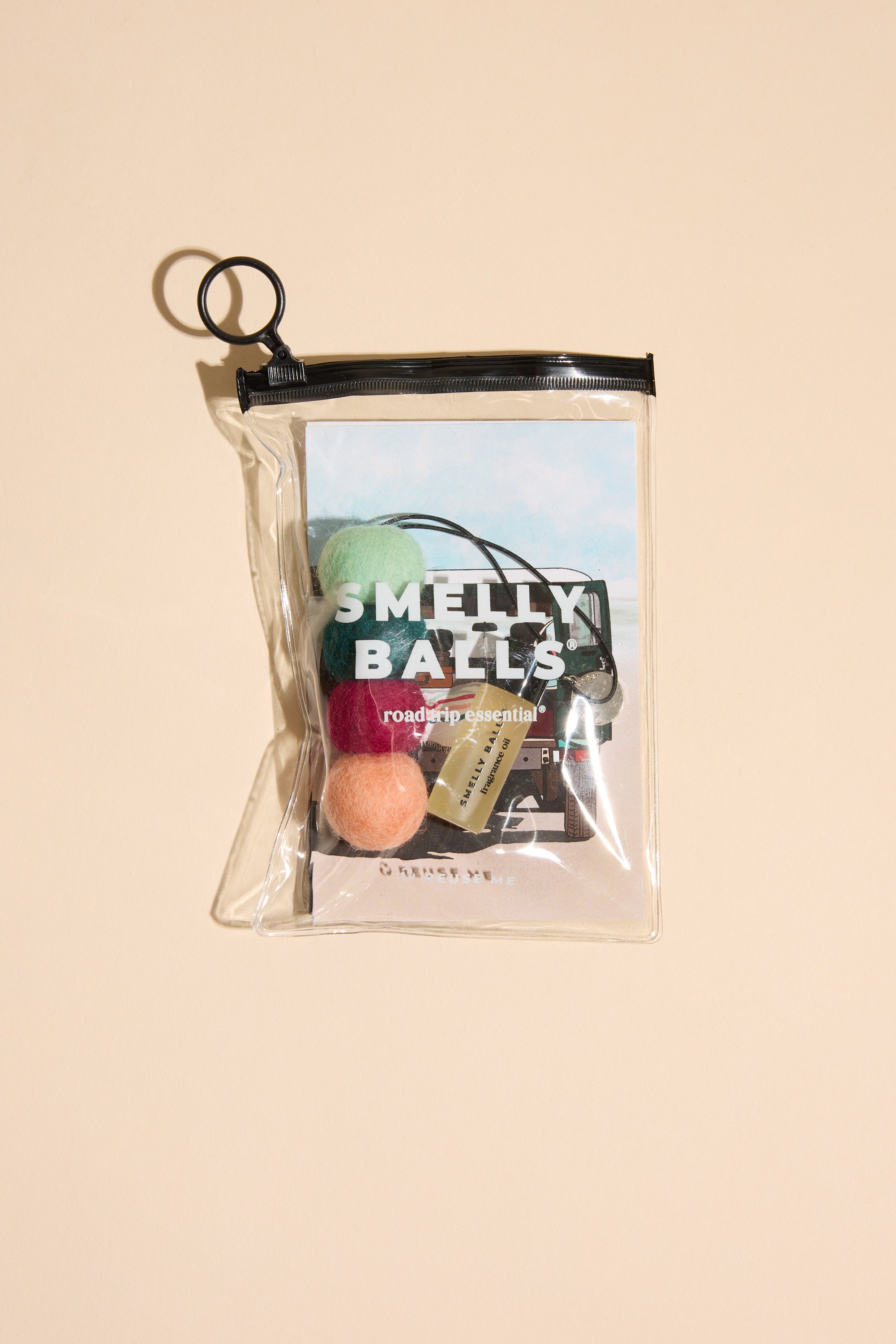 Other's Smelly Balls: Roadie / Tobacco Vanilla set features four colorful balls, a Tobacco Vanilla fragrance vial, and a car-illustrated card in a clear zippered pouch, shown against a beige background.
