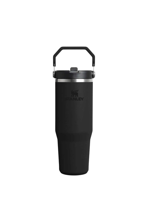 The Stanley IceFlow Flip Straw Tumbler 30 OZ is a black vacuum insulated travel mug with a sturdy handle, flip straw lid, and Stanley logo on the front, shown against a plain white background.