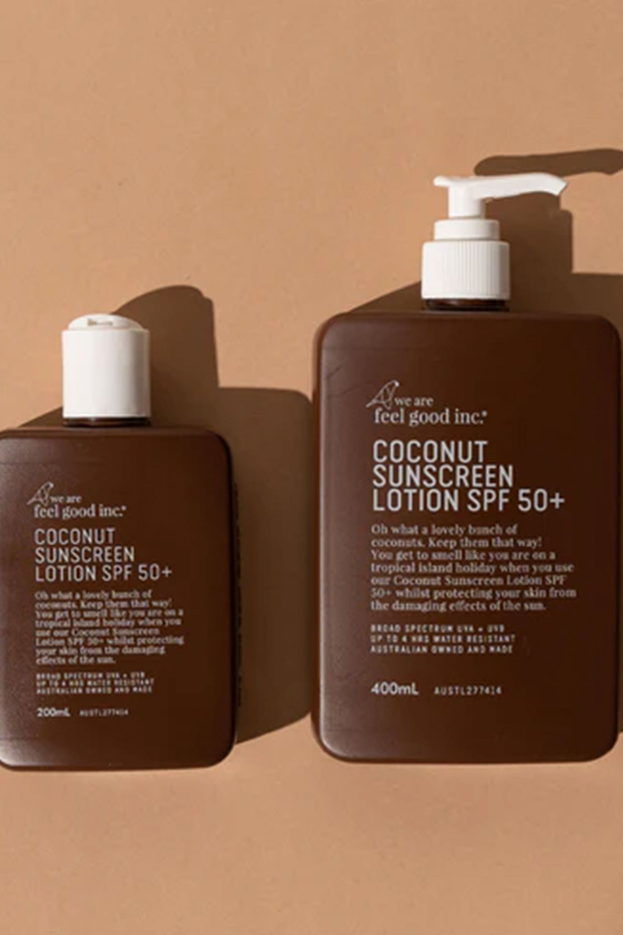 A brown bottle of Other Coconut Sunscreen Lotion SPF50+ 75ml (Traveller)—broad spectrum and water resistant—sits on a beige background, featuring a white cap.