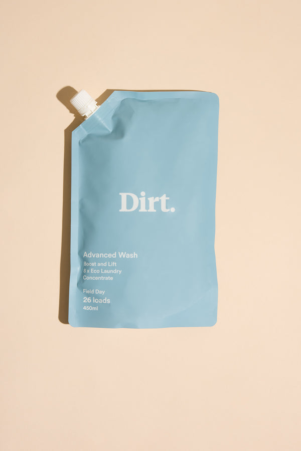 A blue refill pouch of Other Advanced Wash Starter Pack laundry detergent rests on a beige surface. The pouch, labeled Field Day, has a white screw cap and minimalist text highlighting odour removal, 490ml for 26 loads.