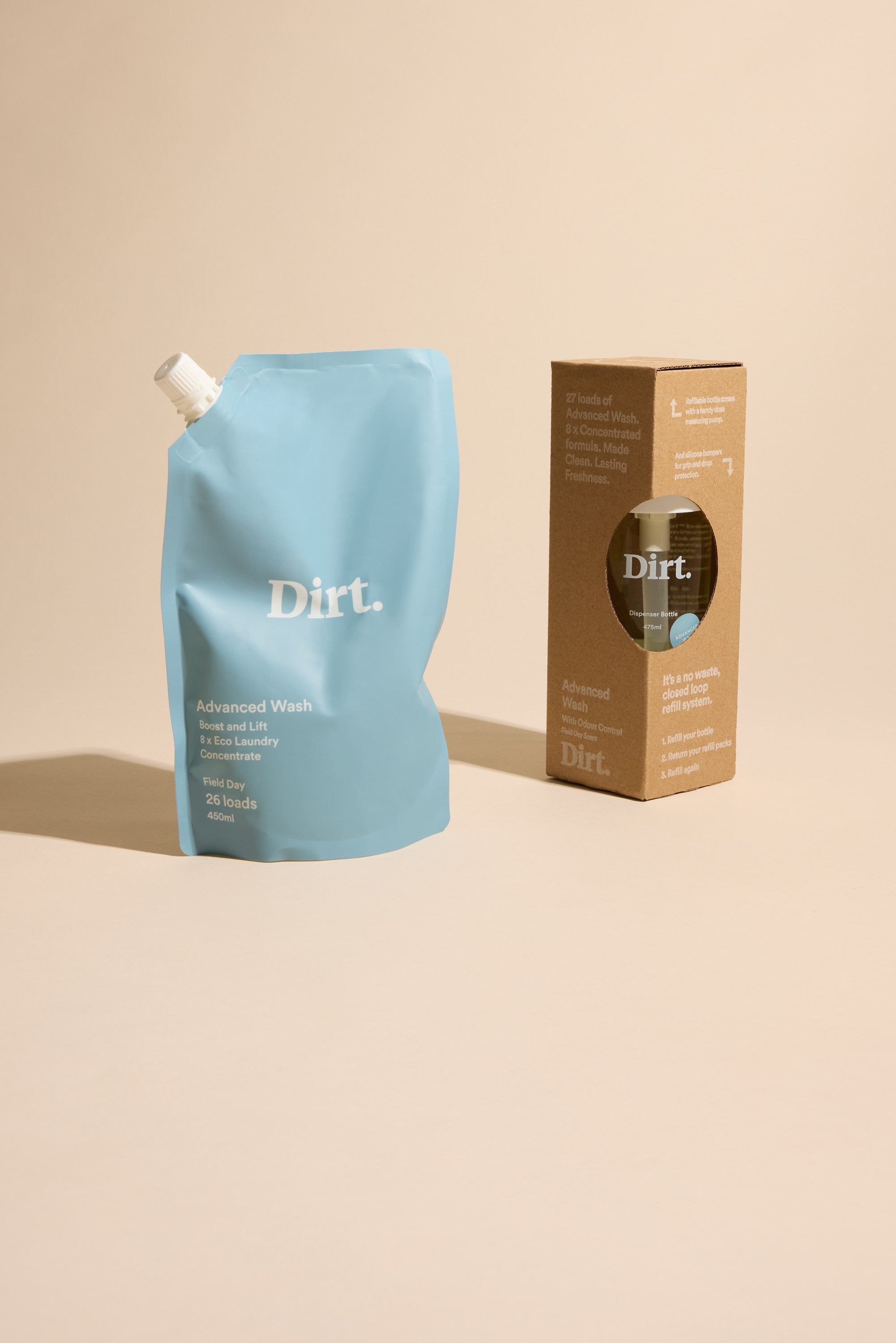 A blue Dirt. laundry detergent refill pouch is next to an Other Advanced Wash Starter Pack box, which has a round cutout showing the matching bottle inside, both set against a plain beige background.