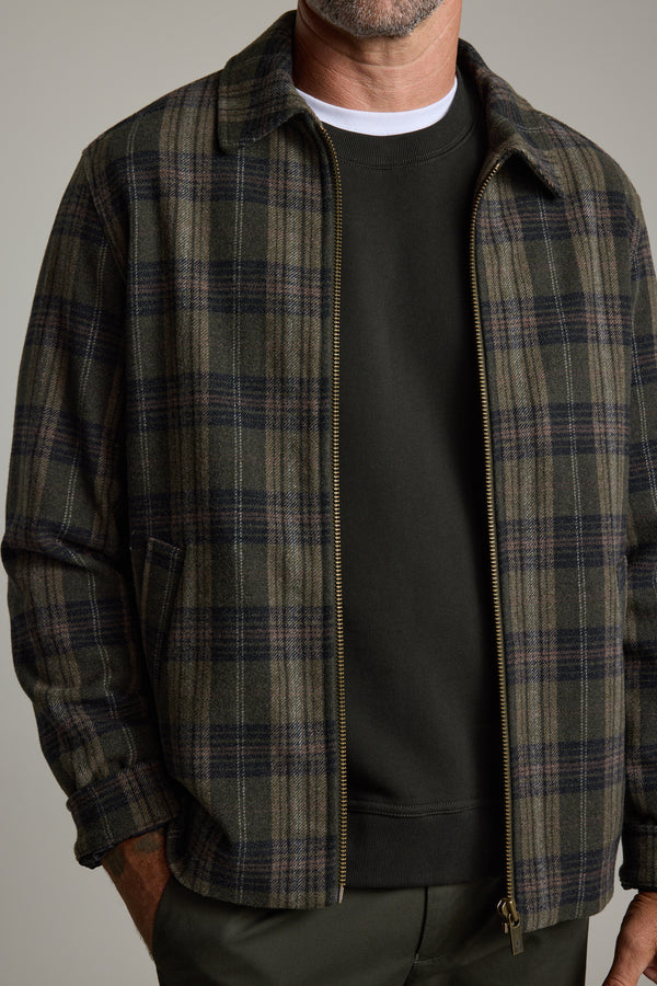Man in Barkers Zermatt Wool Jacket over dark sweatshirt and green pants, cropped at neck.