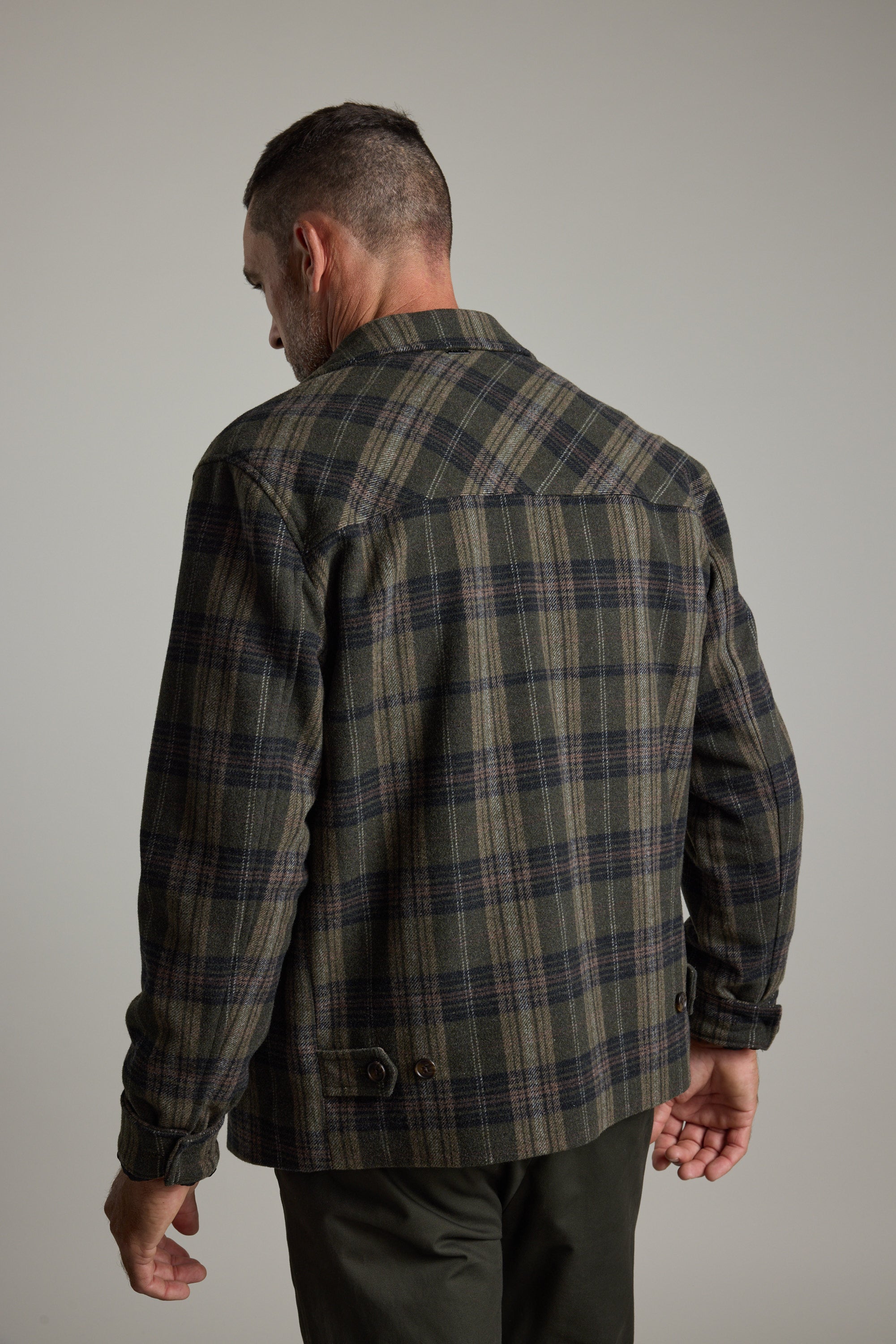 Man wearing Barkers Zermatt Wool Jacket, back turned, head facing left.