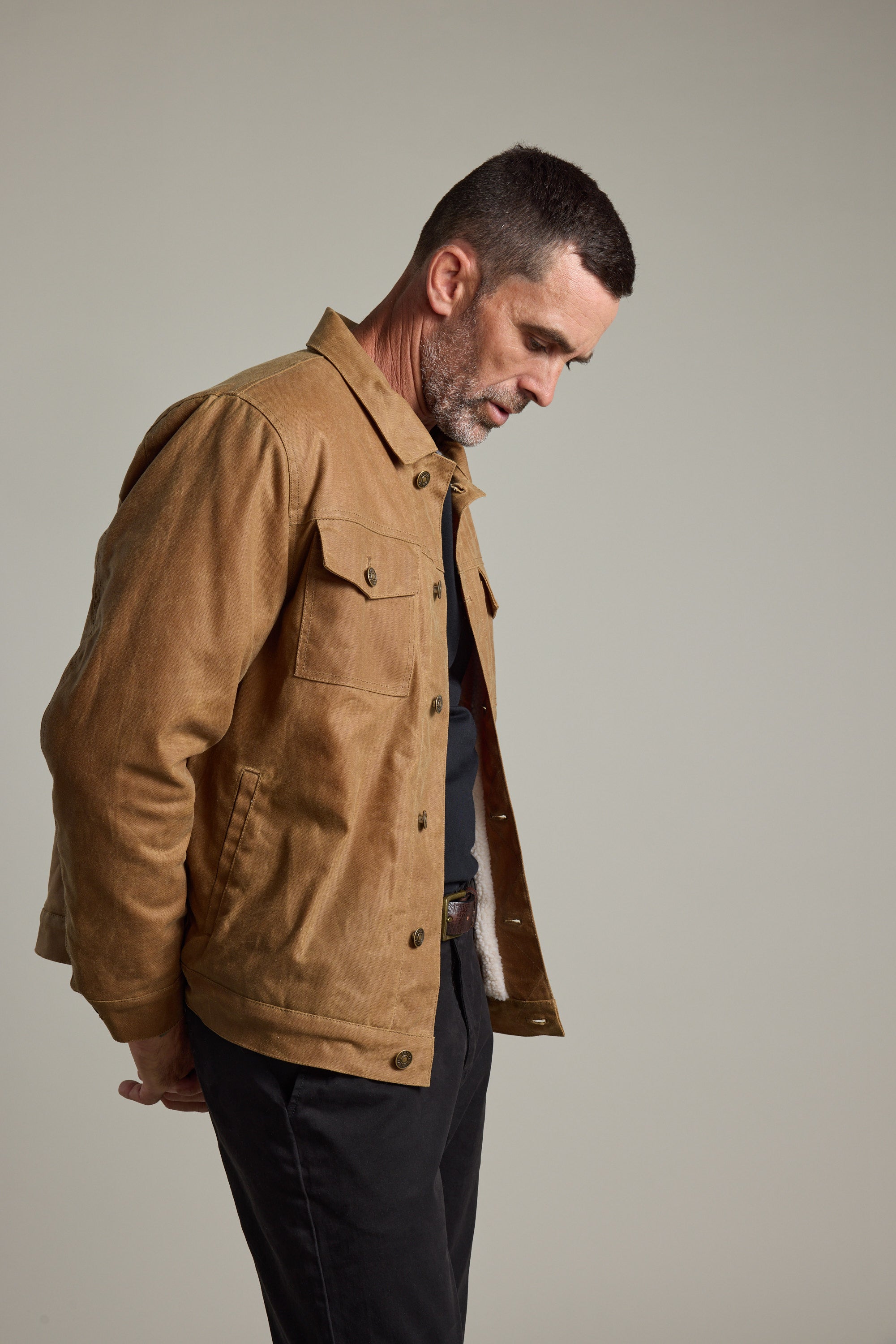Man wearing Barkers Benson Waxed Cotton Sherpa Jacket against a plain light gray background.