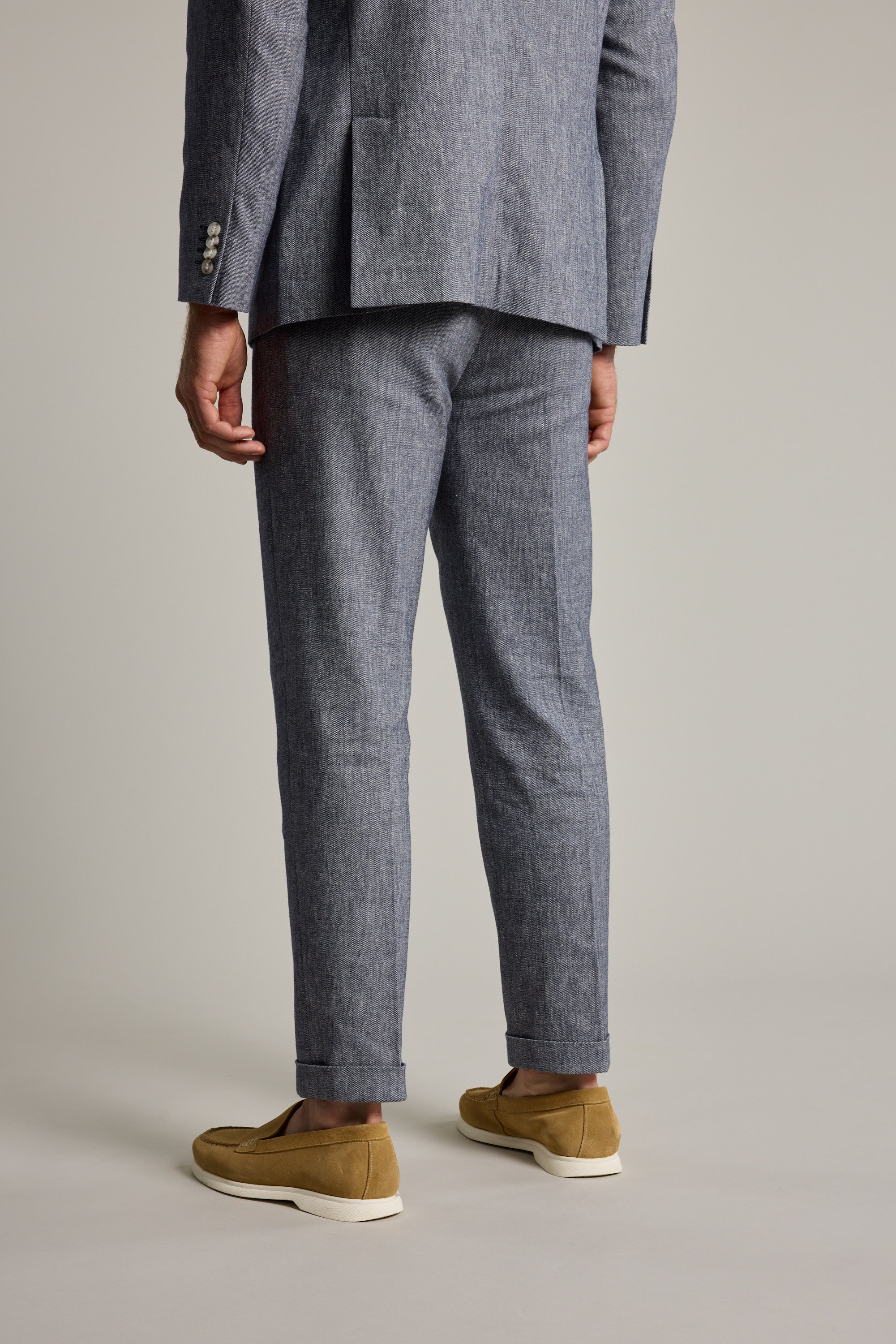 Man wears Barkers Paden Twill Pant, blue, shown from the back against a plain background.