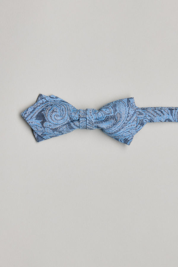 The Barkers Parisian Lincoln Bow Tie, in light blue with swirling paisley and subtle fleur-de-lis patterns, is handmade in New Zealand and shown on a plain white background.