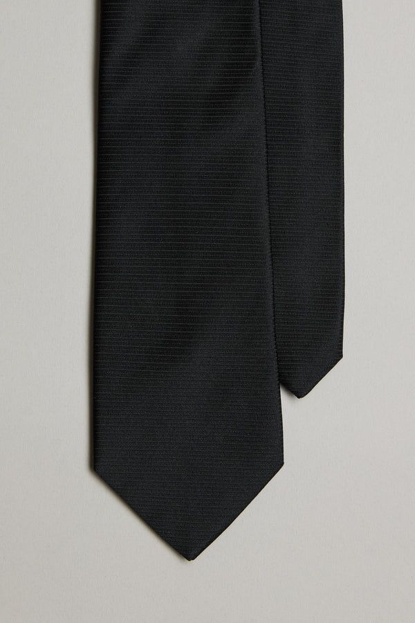 A close-up of the Barkers Black Tie features its subtle jacquard print on the bottom ends, set against a light gray background.