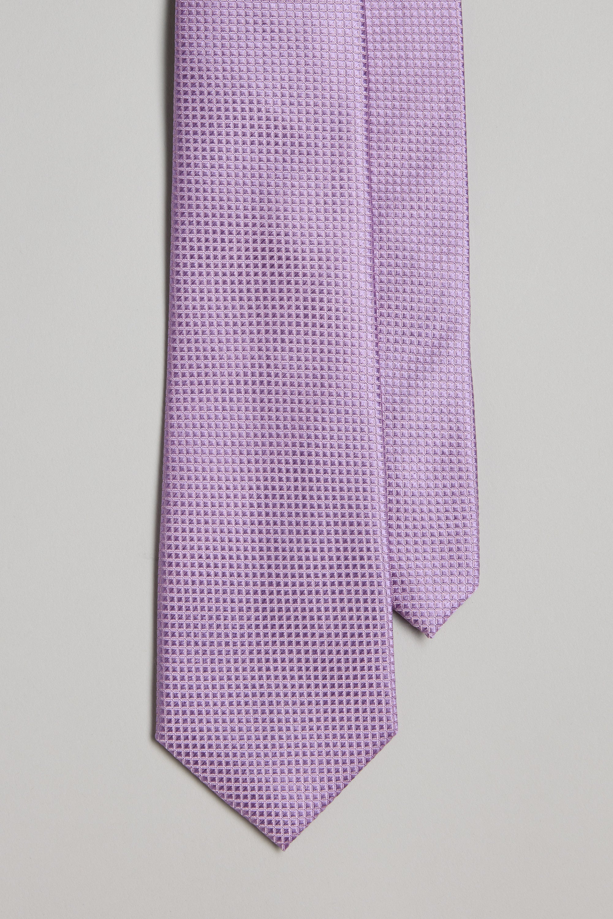 The Barkers Doyers Texture Tie features a light purple hue with a subtle geometric pattern, shown on a light gray background—ideal for pairing with silk accessories such as pocket squares.