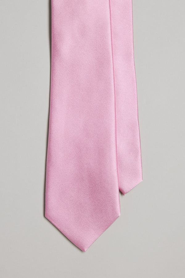 A close-up of the Cumberland Tie by Barkers, a light pink silk necktie, showcased against a plain light gray background.
