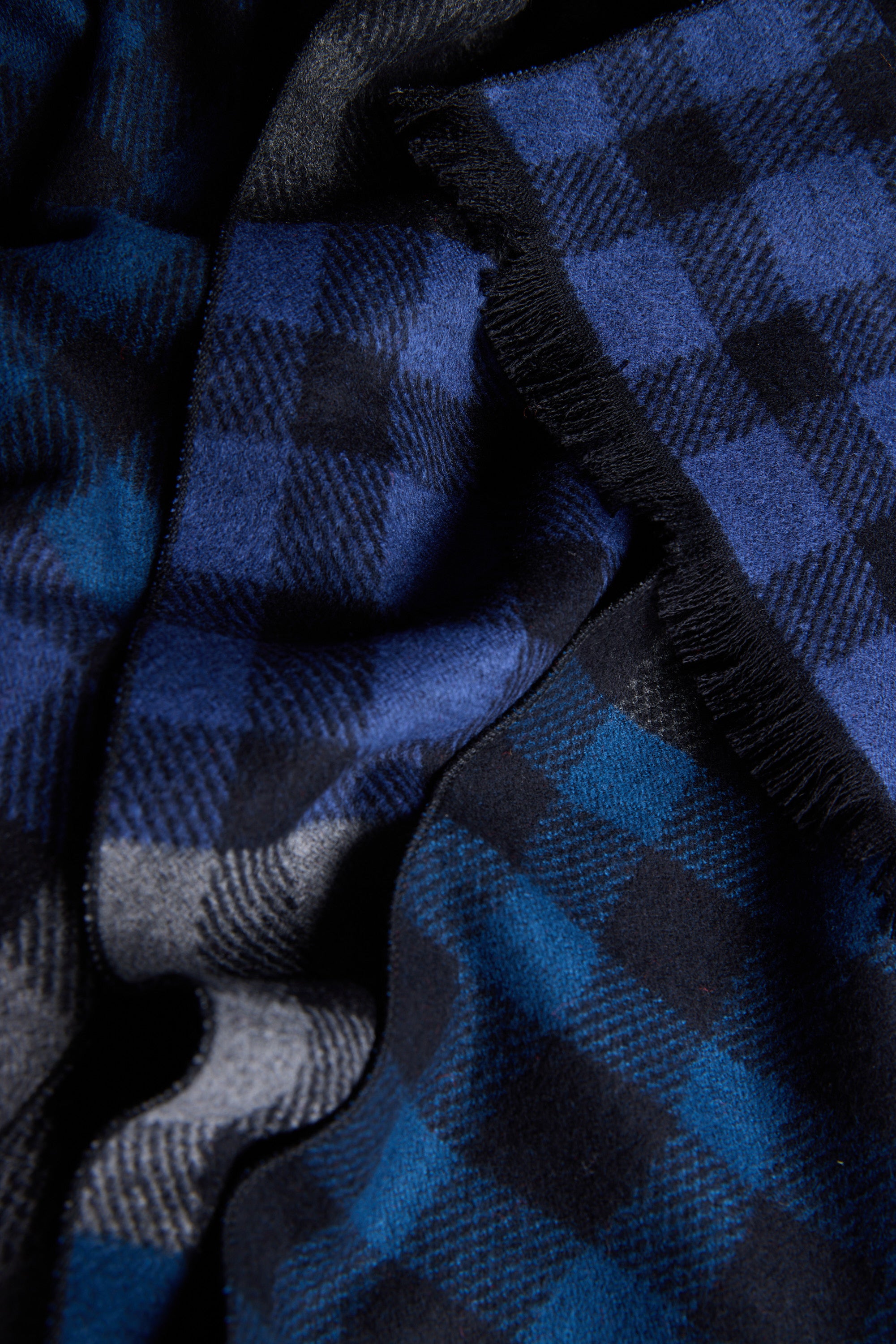Close-up of the Barkers Harper Scarf in a soft blue and black classic plaid check.