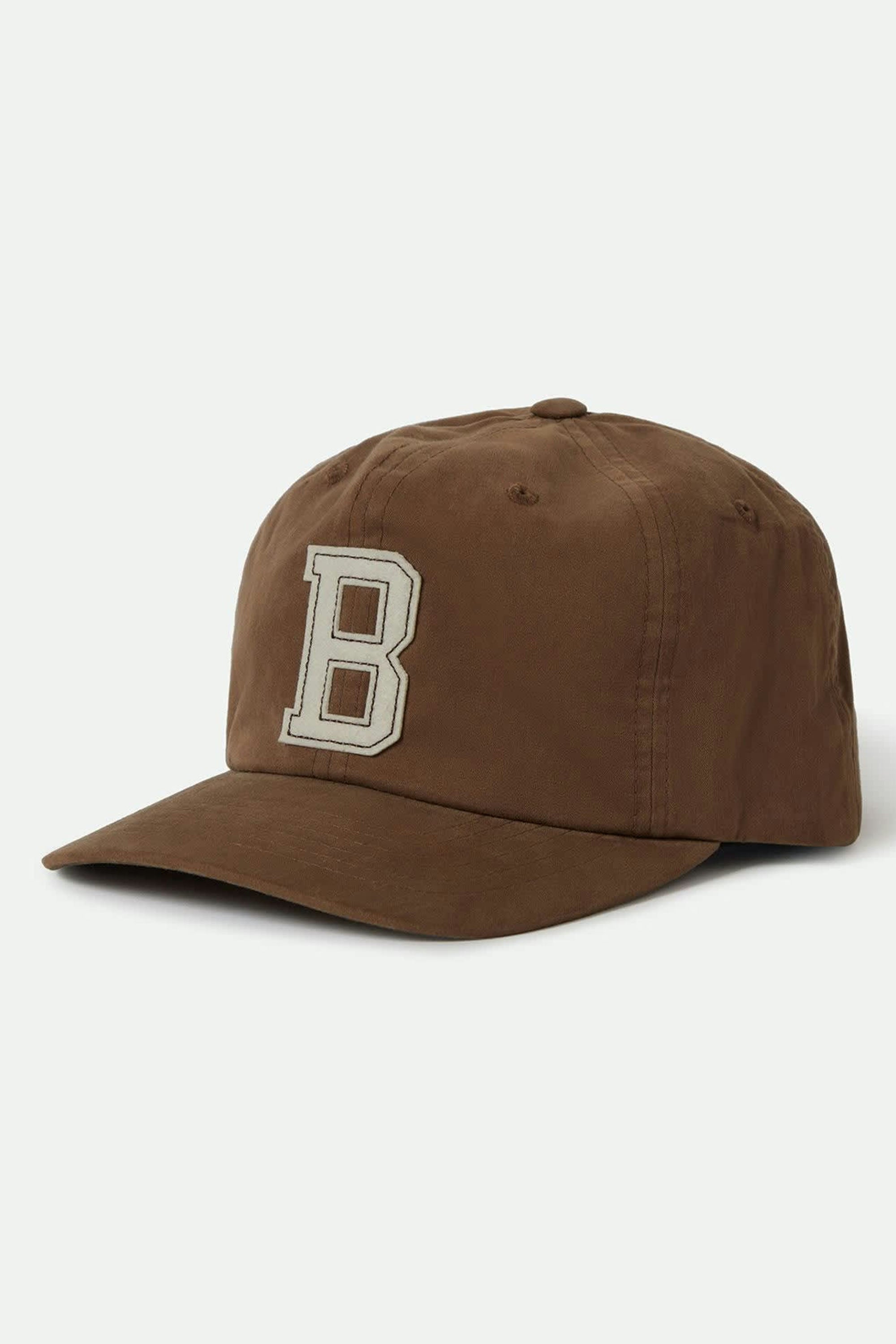 The Brixton Big B MP Cap by Brixton is a brown 6-panel cotton corduroy baseball cap with a large white "B" on the front and an adjustable leather strap, shown against a plain light background.