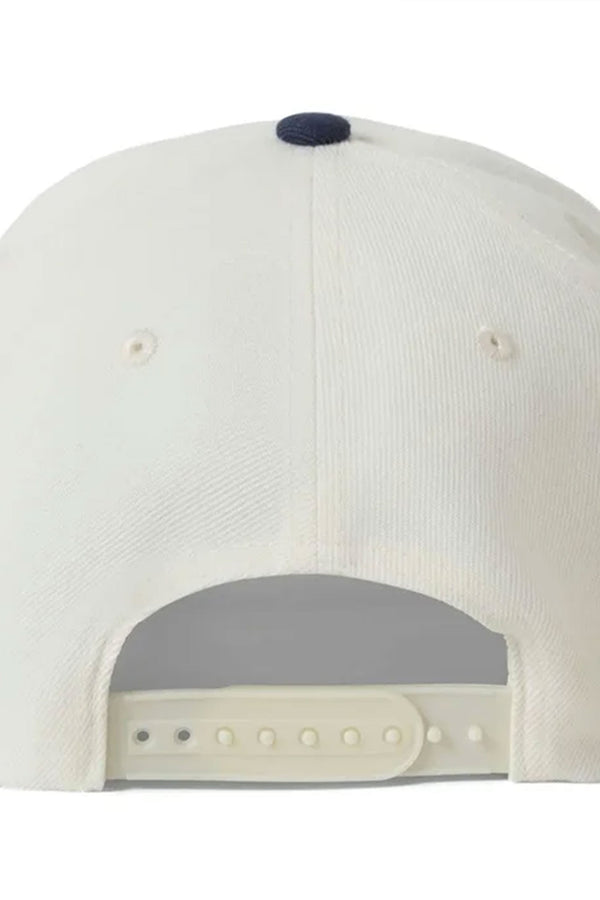 The image features the Brixton Crest Snapback by Brixton, a white baseball cap with an adjustable snapback closure, a small dark top button, and a medium profile design.