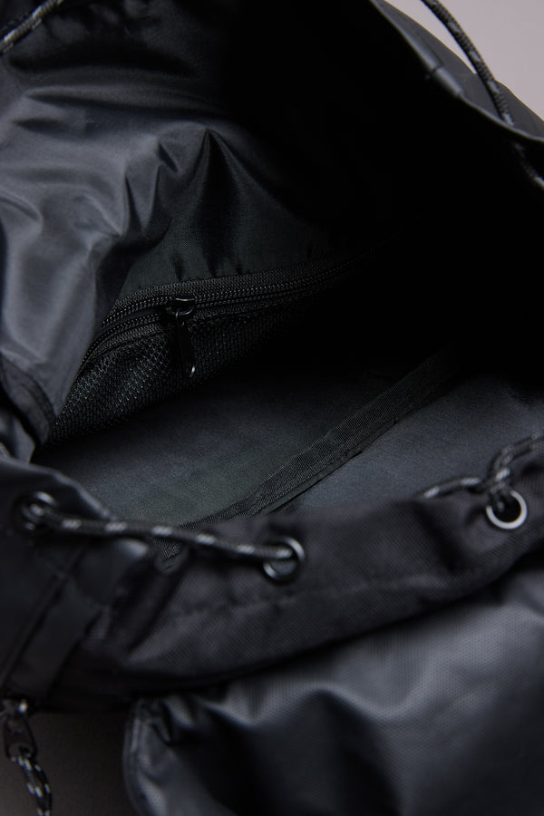 Close-up of the WearEver Transit Backpack interior showing a zippered pocket on the lining, water-resistant zips, and a drawstring closure at the opening.