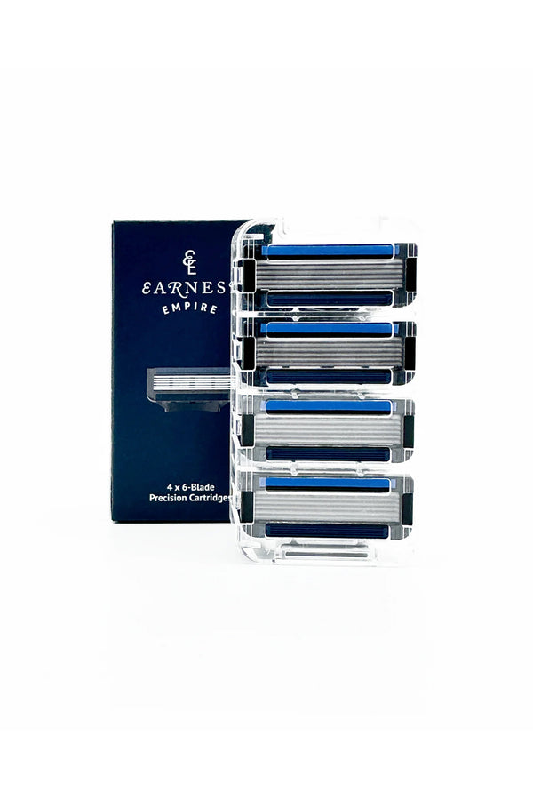 A box labeled Other stands behind a clear plastic case containing four Earnest Empire 6 blade cartridges, each with blue lubricating strips, shown on a white background.