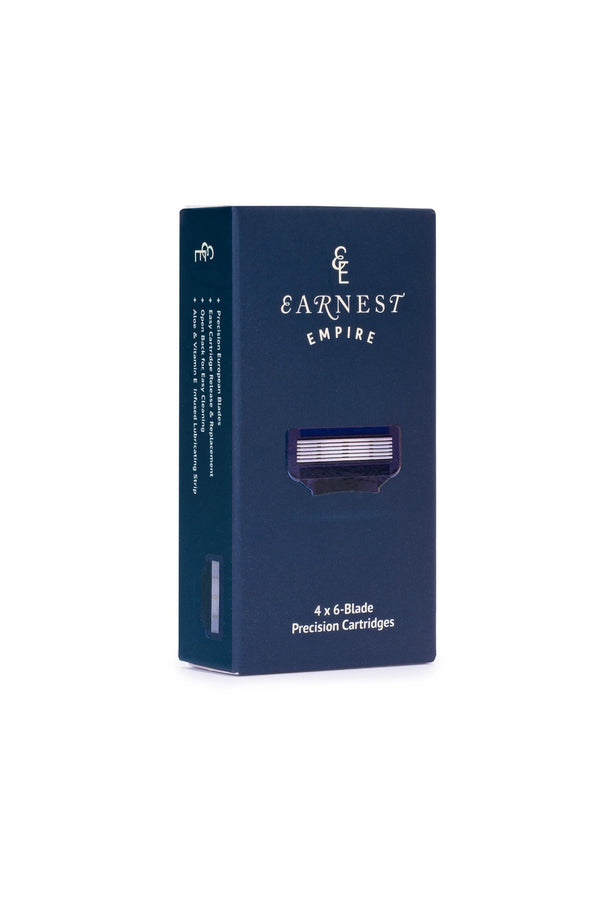 Dark blue box of Other brand Earnest Empire 6 blade cartridges – 4 pack, with a window displaying one cartridge. The packaging features white branding and details precision blades designed for a close, smooth shave.
