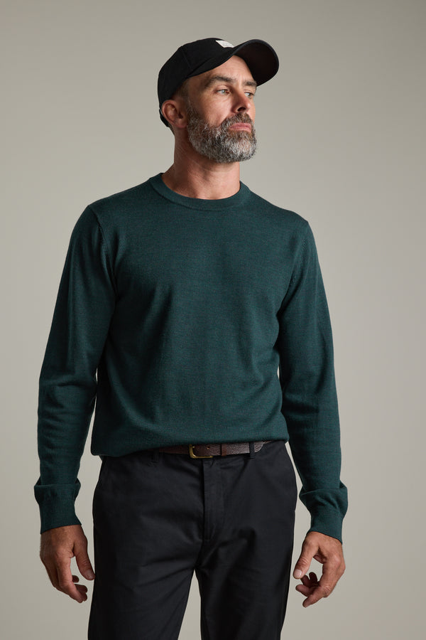 Man with gray beard wears Barkers Skyland ZQrx Merino Crew and black cap indoors.