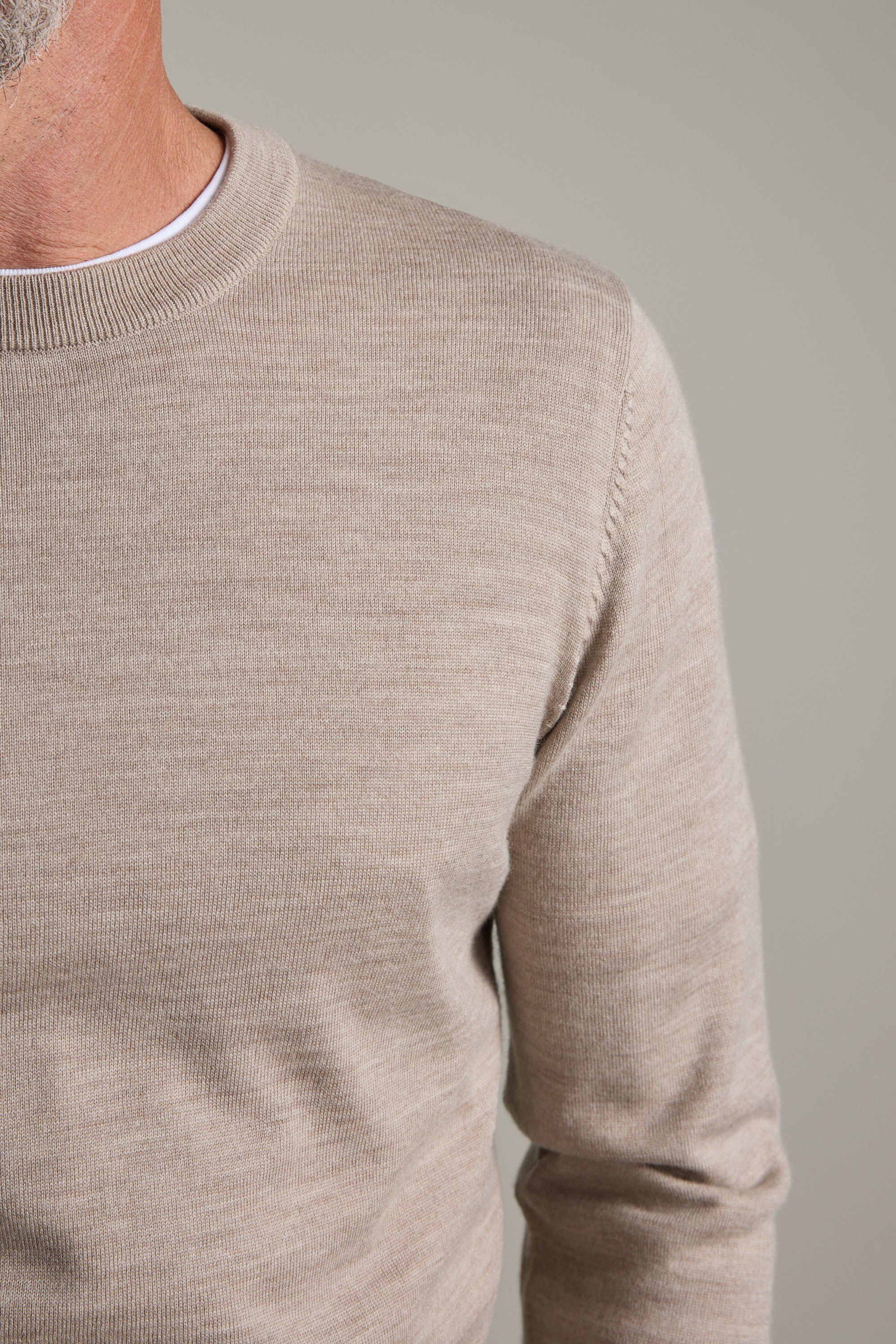 Man wearing a light beige Barkers Skyland ZQrx Merino Crew; only his torso and part of face shown.