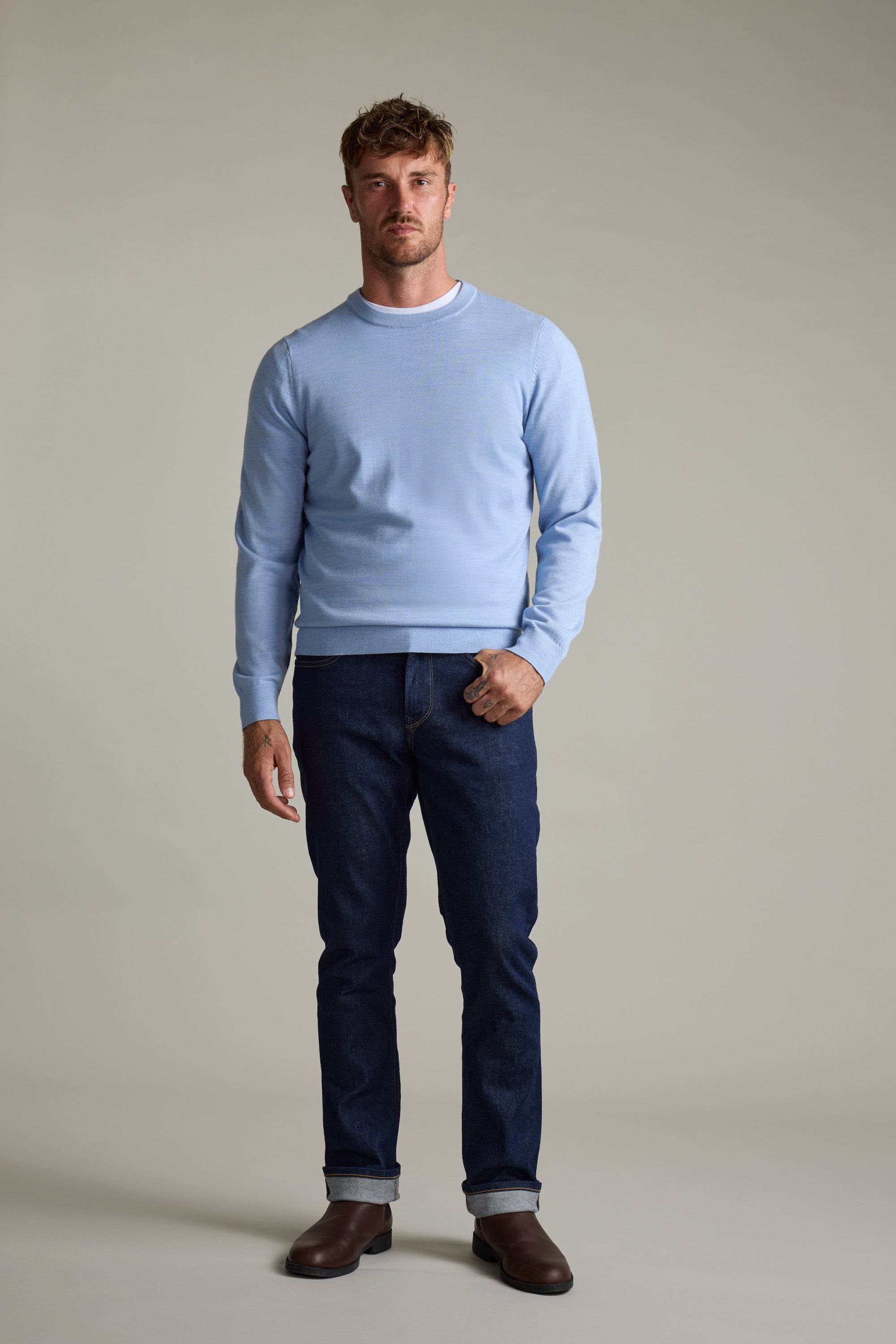 Man in a Barkers Skyland ZQrx Merino Crew, dark jeans, and brown boots.