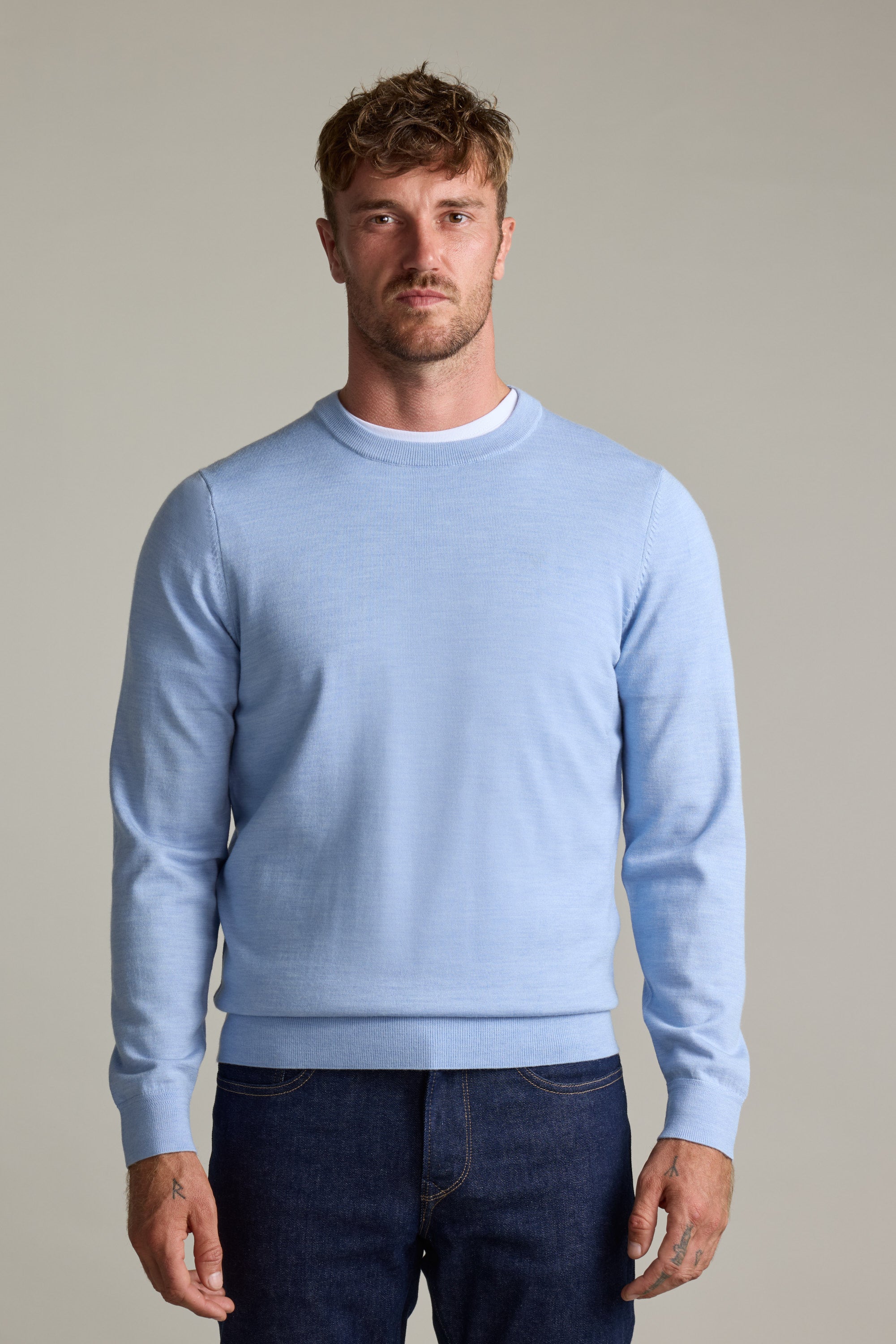Man wearing Barkers Skyland ZQrx Merino Crew sweater and dark jeans, against a plain background.
