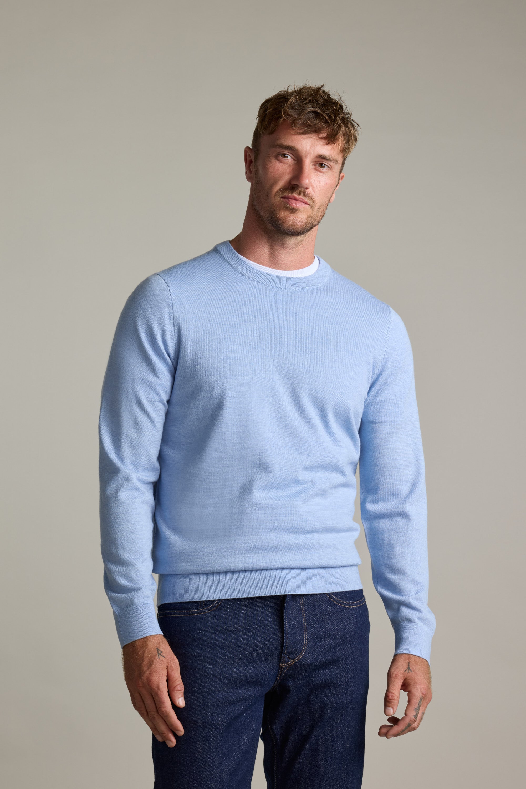 Man in Barkers Skyland ZQrx Merino Crew sweater and jeans, against a plain light background.