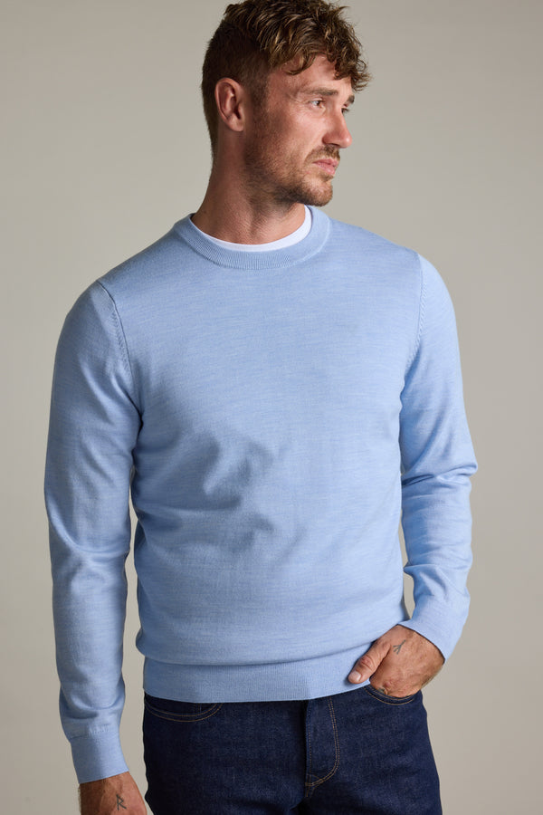 Man in a Barkers Skyland ZQrx Merino Crew and dark jeans against a plain background.