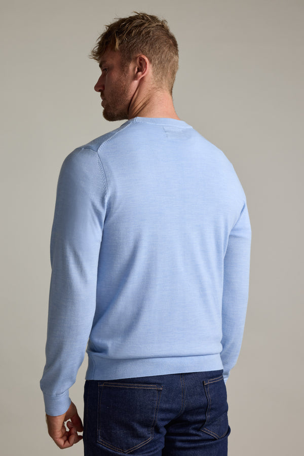Man in a Barkers Skyland ZQrx Merino Crew sweater and dark jeans, back to the camera.